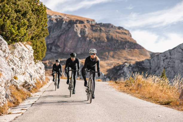 Confident professional cyclists on their road bikes, surrounded by the rugged beauty of nature.